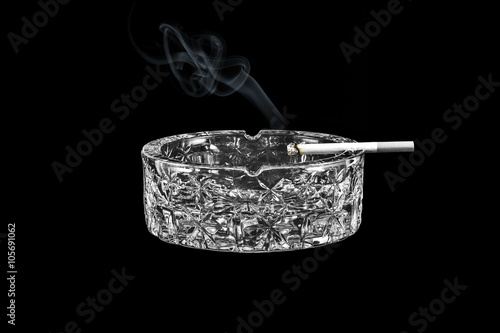 Fotografija Glass ashtray with a cigarette