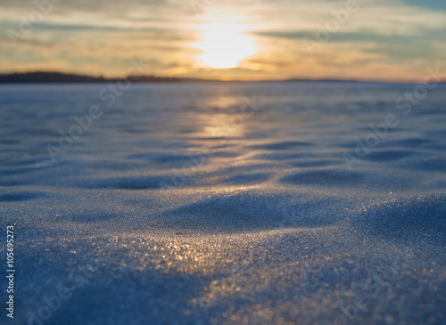 Blurred sunset at a lake in the winter. Very shallow depth of field used to create the ethereal athmosphere. 