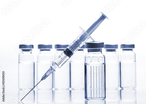 Glass Medicine Vials and Syringe on white background