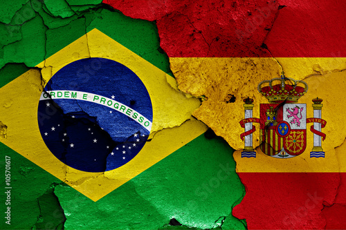 flags of Brazil and Spain painted on cracked wall