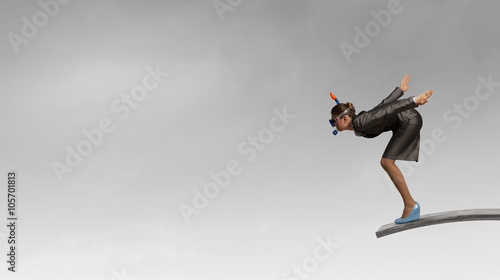 Businesswoman jumping in water