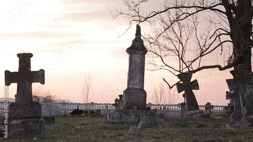 It is very old cemetery. There are many graves from 16 to 21 centuries. It was shot just before sunset therefore some lightflares are very real. Full HD video shot with Canon 6d 25fps and slider. photo