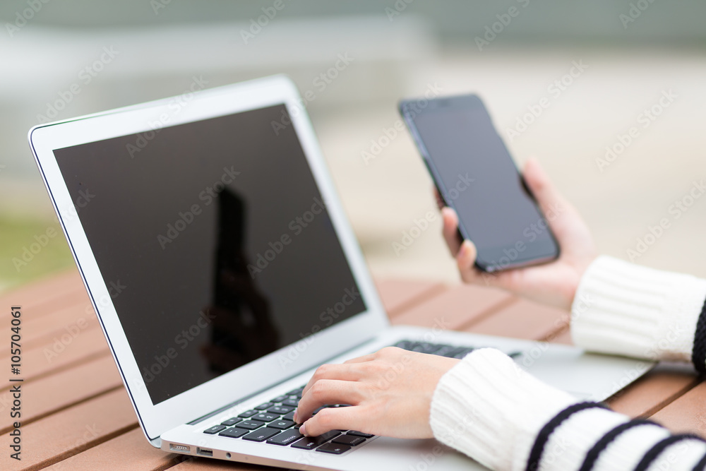 Woman use of laptop computer and cellphone Woman use of laptop computer and cellphone