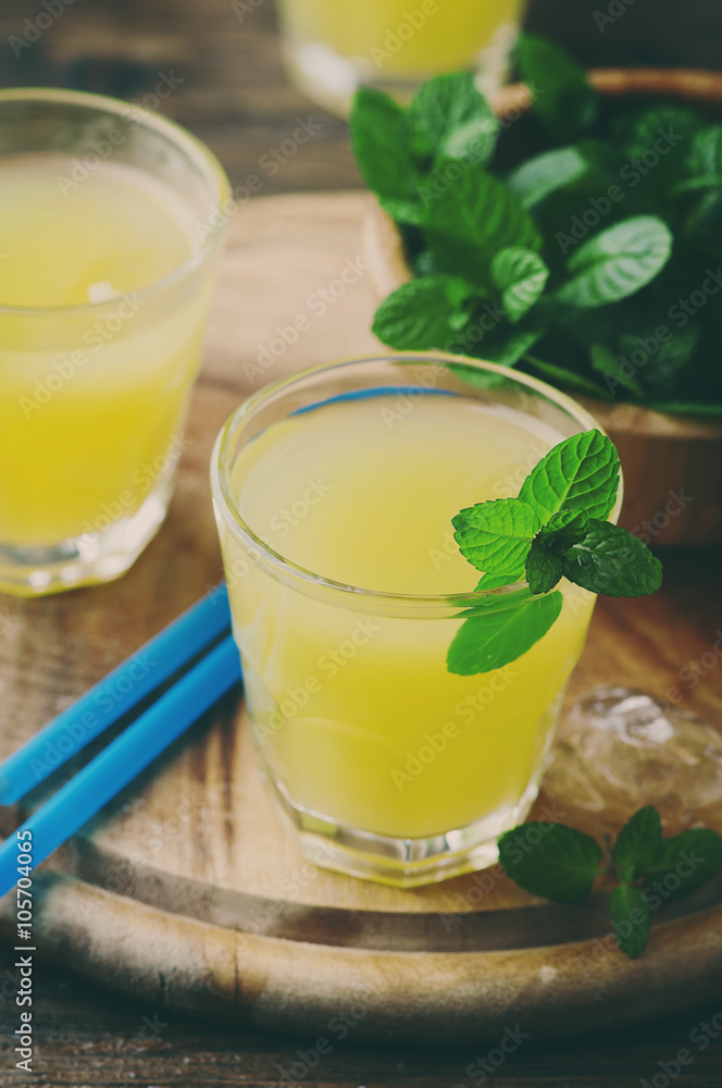 Yellow fresh cocktail with mint and ice Yellow fresh cocktail with mint and ice