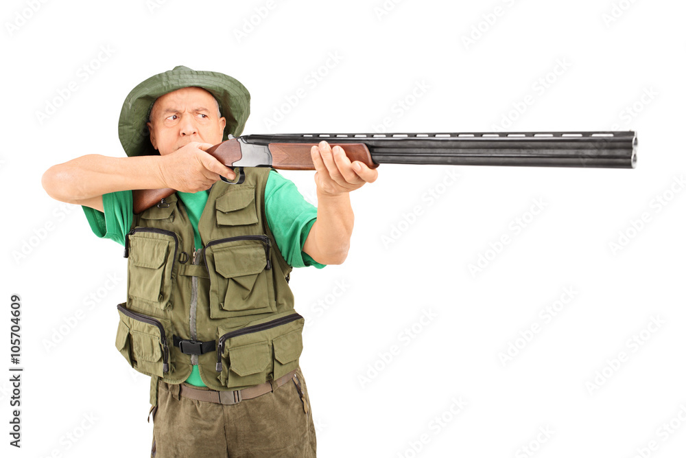 Mature hunter aiming with a rifle Mature hunter aiming with a rifle