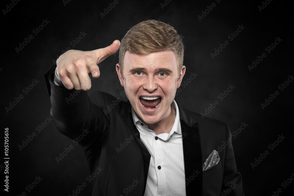 Young business man pointing at the camera.
