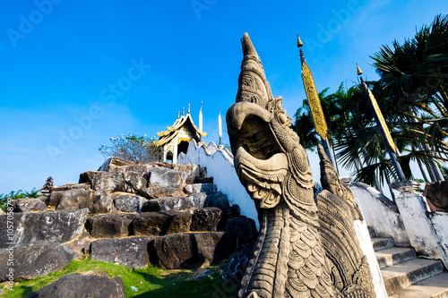 king of Nagas andBeautiful Thai Temple with blue sky photo