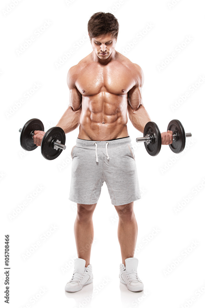 Muscular bodybuilder guy doing exercises with dumbbells Muscular bodybuilder guy doing exercises with dumbbells