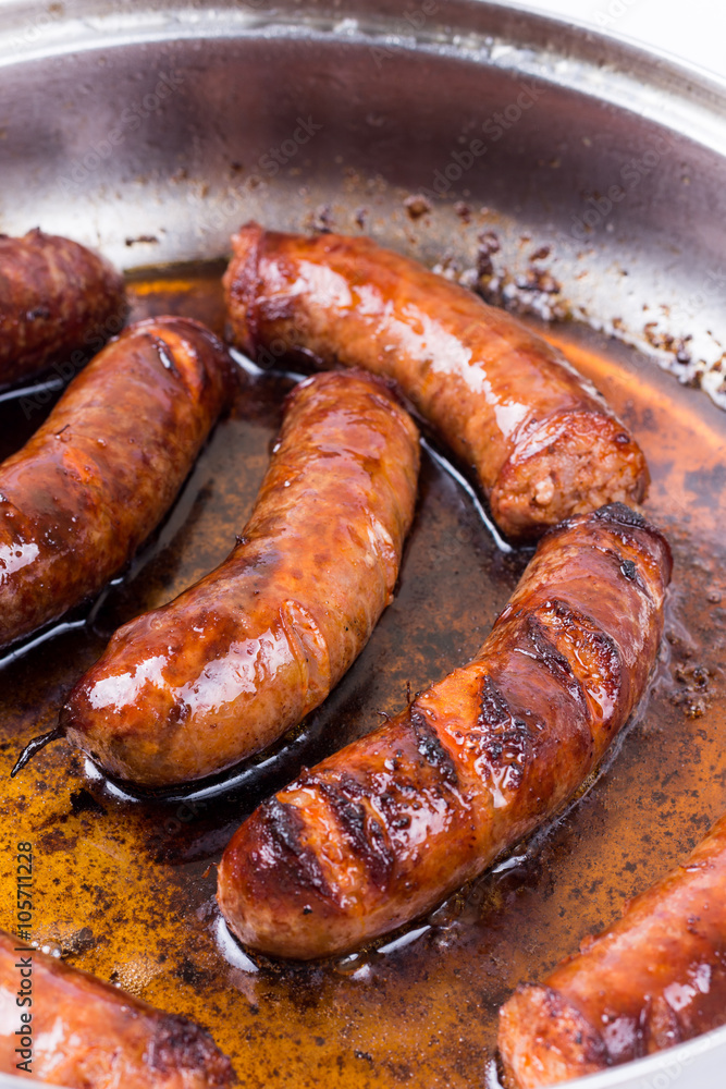 Homemade sausages frying in fat Homemade sausages frying in fat