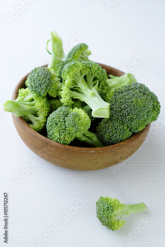 fresh broccoli in wooden bowl