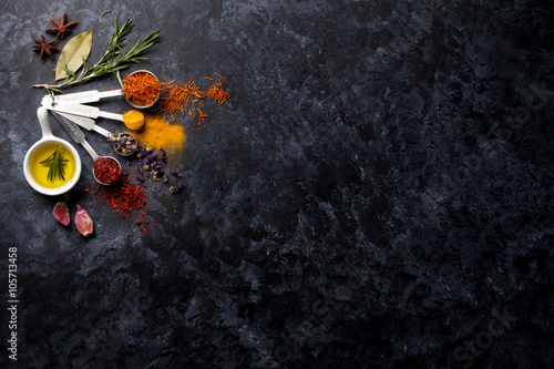 Fototapeta Naklejka Na Ścianę i Meble -  Herbs and spices over black stone