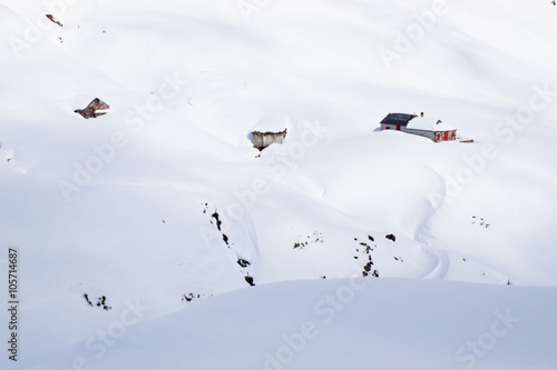 huts in the mountain covered of snow