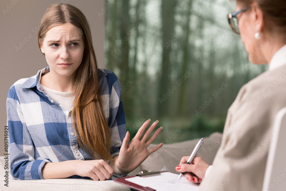 Introvert girl refusing to talk with specialist Introvert girl refusing to talk with specialist