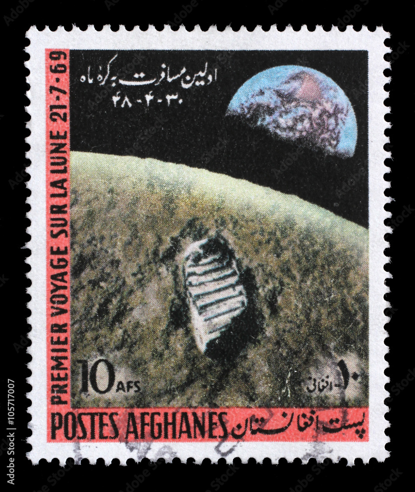 Obraz premium Stamp printed in the Afghanistan shows First Moon Landing - 1969, circa 1970.