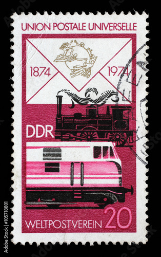 Stamp printed in GDR shows Old Steam Locomotive and Modern Diesel, Centenary of the UPU, circa 1974