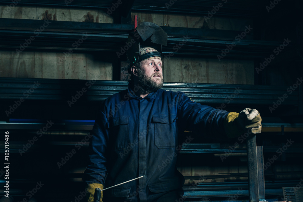 Portrait of welder with beard in workplace