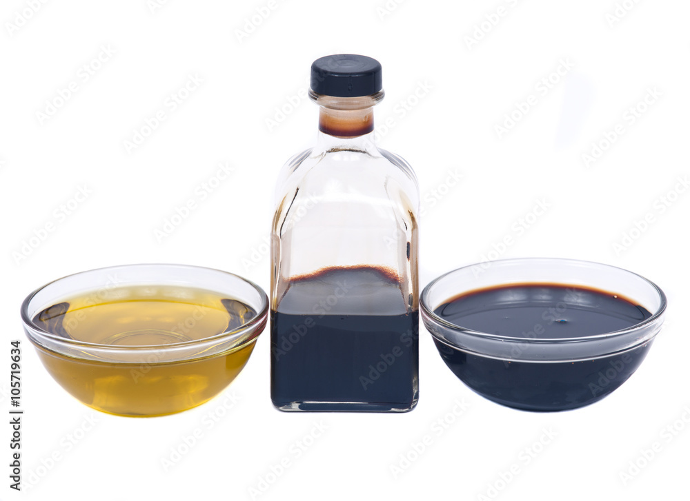 Extra virgin oil and balsamic vinegar in bowl separated on white background Extra virgin oil and balsamic vinegar in bowl separated on white background