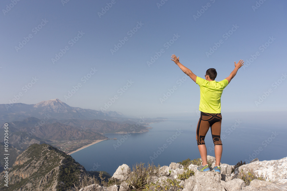 Young man on a mountain top on a sunny day.