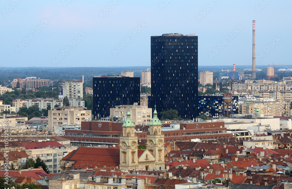 Basilica of the Sacred Heart of Jesus and the new metal and black glass office buildings in the center of the city in the background in Zagreb, Croatia