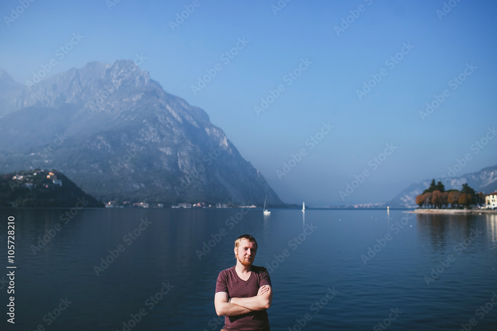 bearded man on the background of a mountain lake Como