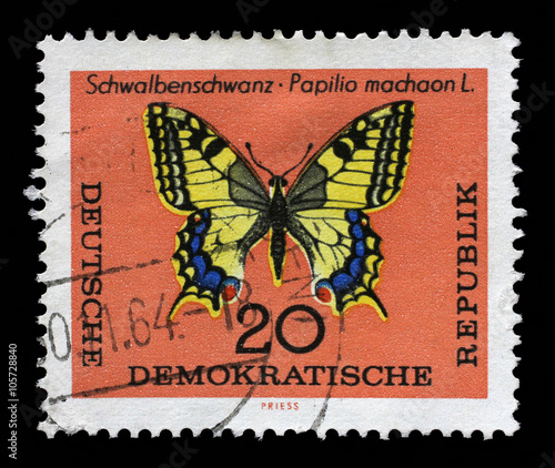 Stamp printed in DDR shows Schwalbenschwanz Papilio machaon L butterfly. The largest butterfly in Germany with a wingspan from 50 to 75 millimeters.