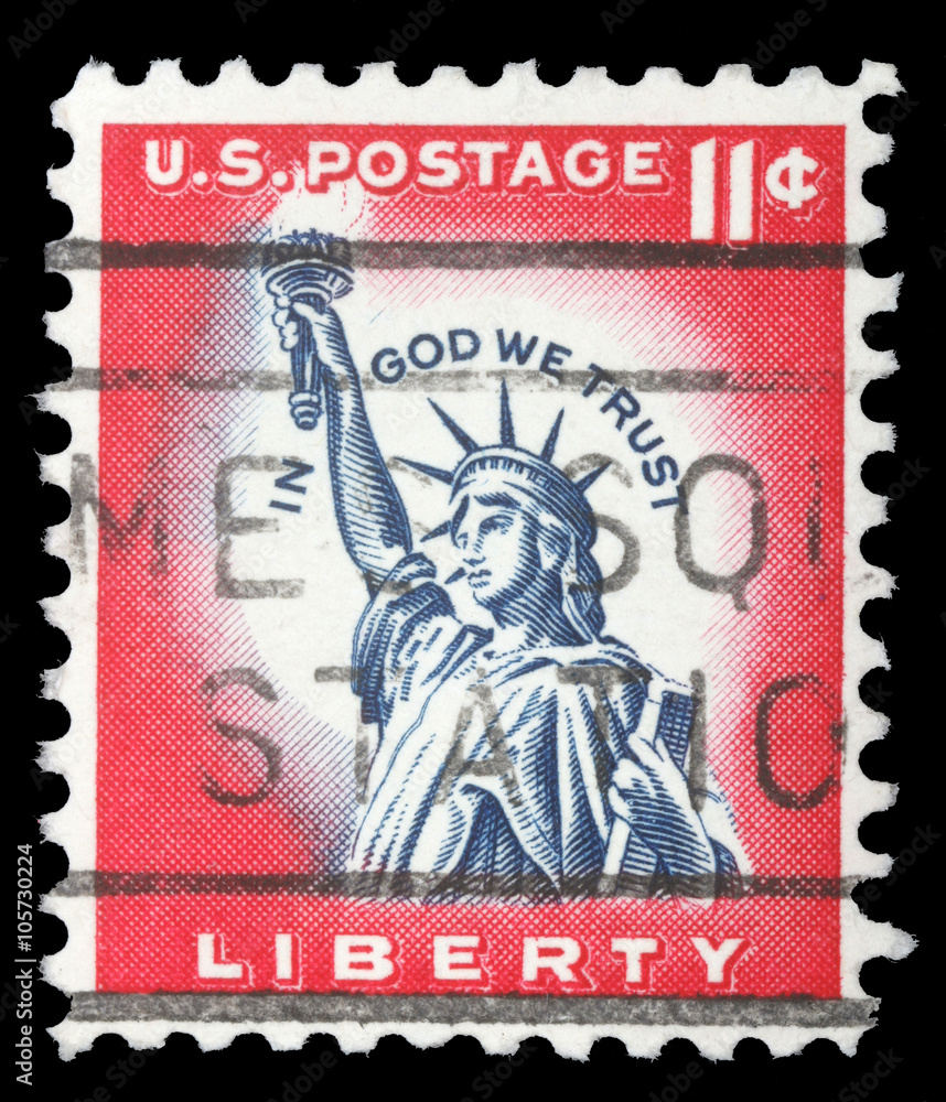 Stamp printed in the United States features statue of liberty and inscription In god we trust, circa 1970