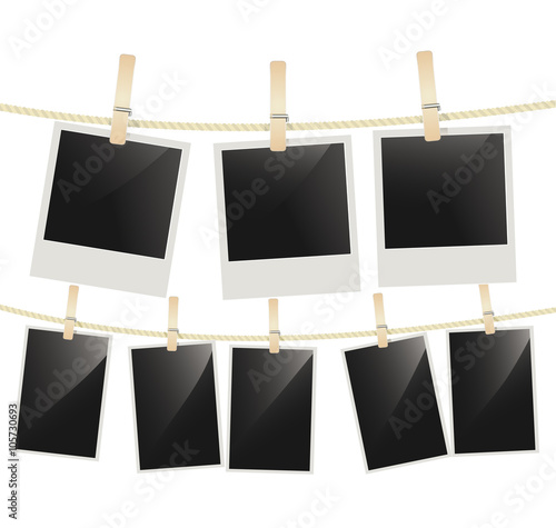 Photo frames hanging on clothesline with clothespins on white