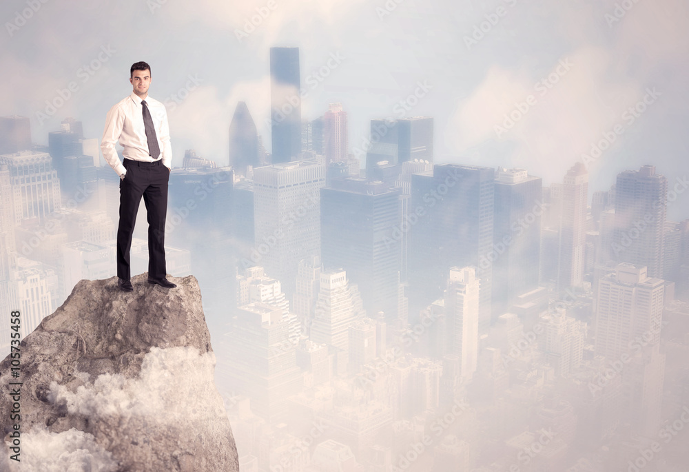 Winner urban businessman on top of stone Winner urban businessman on top of stone