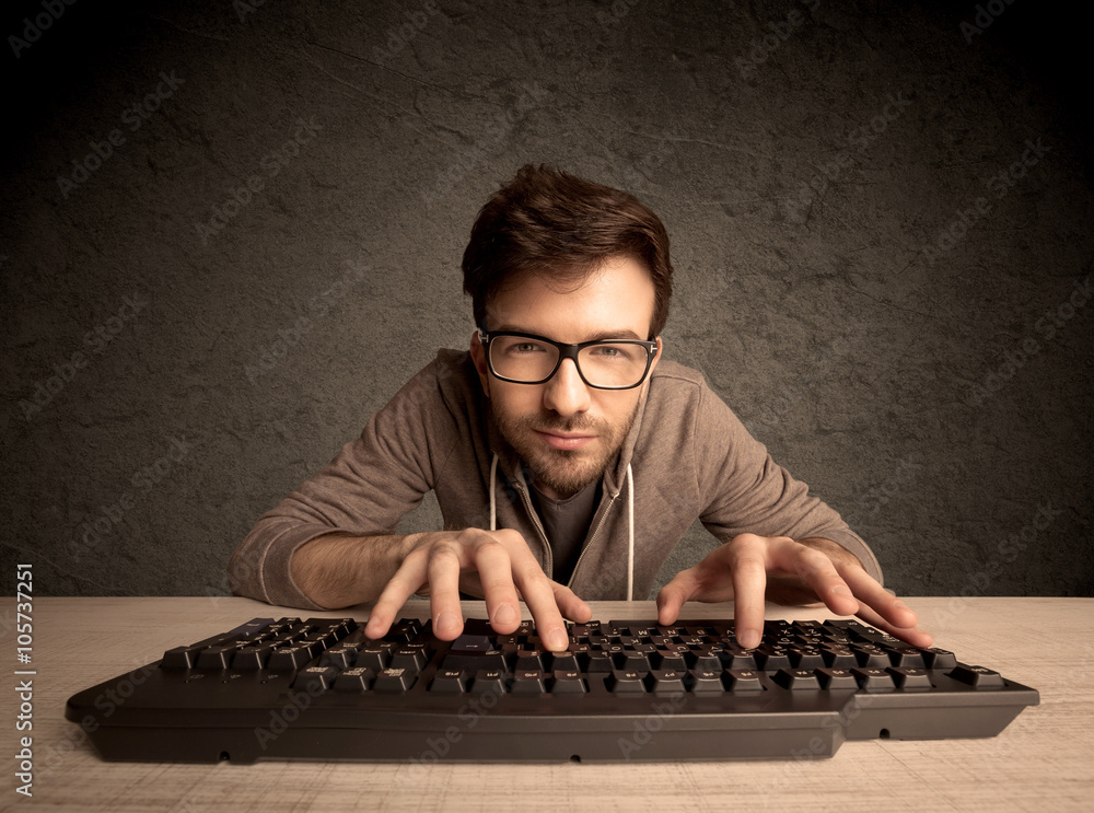 Computer geek typing on keyboard StockFoto Adobe Stock