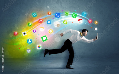 Running businessman with application icons from device © ra2 studio