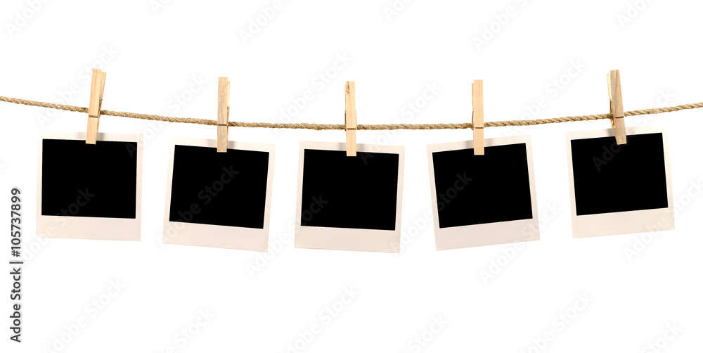 Several blank polaroid style instant photo print frames hanging - obrazy, fototapety, plakaty 