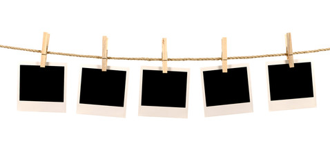 Several blank polaroid style instant photo print frames hanging