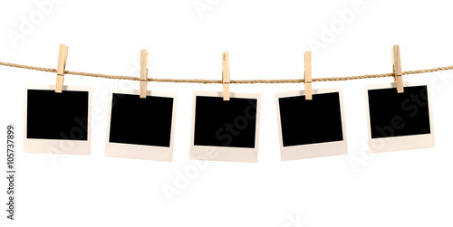 Several blank polaroid style instant photo print frames hanging photo