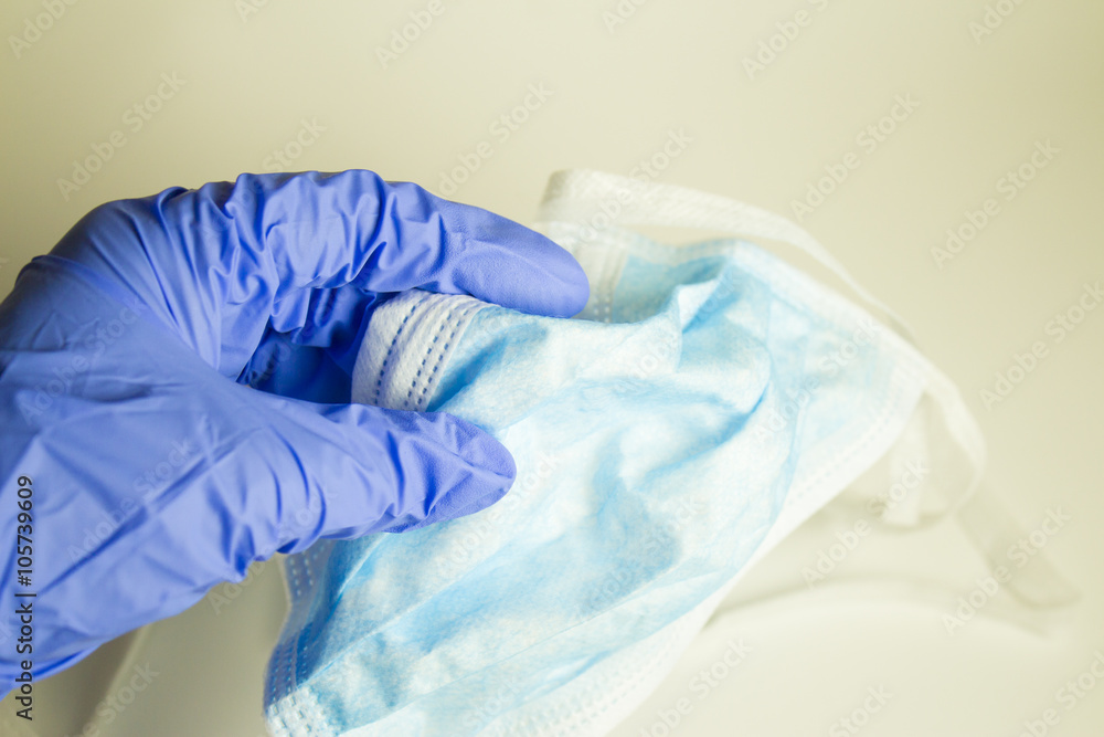 Hand taking a facemask