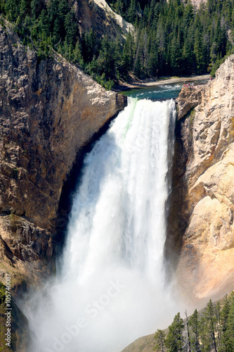 People are standing on a platform next to the Lower Falls 