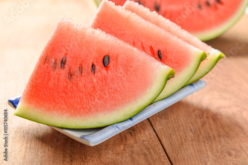 slices of watermelon on wooden background