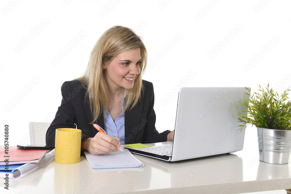 happy Caucasian blond business woman working on laptop computer at modern office desk happy Caucasian blond business woman working on laptop computer at modern office desk