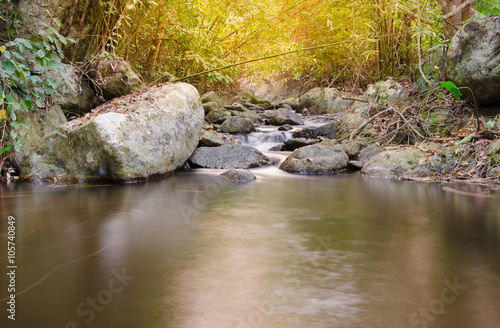 Waterfall in the tropical forest with sunlight, Thailand photo