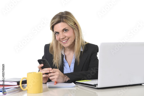 happy Caucasian blond business woman working using mobile phone at office computer desk