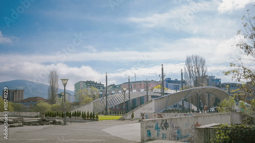 KOSOVSKA MITROVICA - SEPTEMBER 2014:Bridge dividing the two parts of the town-Serbian and Kosovar Albanian  photo