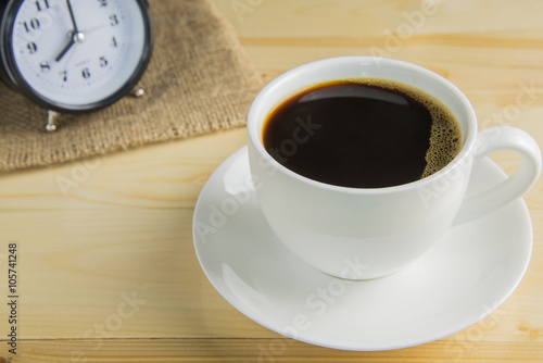 Black coffee in cup of coffee on wooden background photo