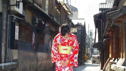 Japanese girl wearing kimono bows to the camera slow motion