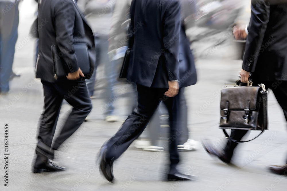 motion blurred business people walking on the street motion blurred business people walking on the street