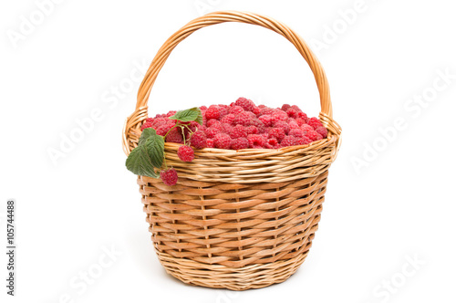 Fresh ripe red raspberries in a wicker bowl 