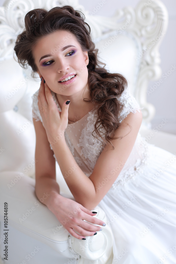 Young gorgeous bride is sitting in antique armchair Young gorgeous bride is sitting in antique armchair
