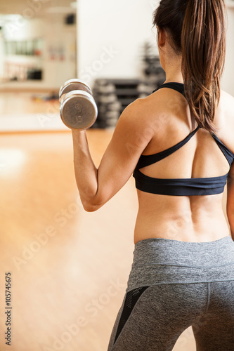 Rear view of a woman doing bicep curls