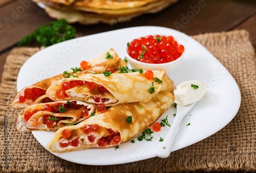 Pancakes with red caviar and cream cheese