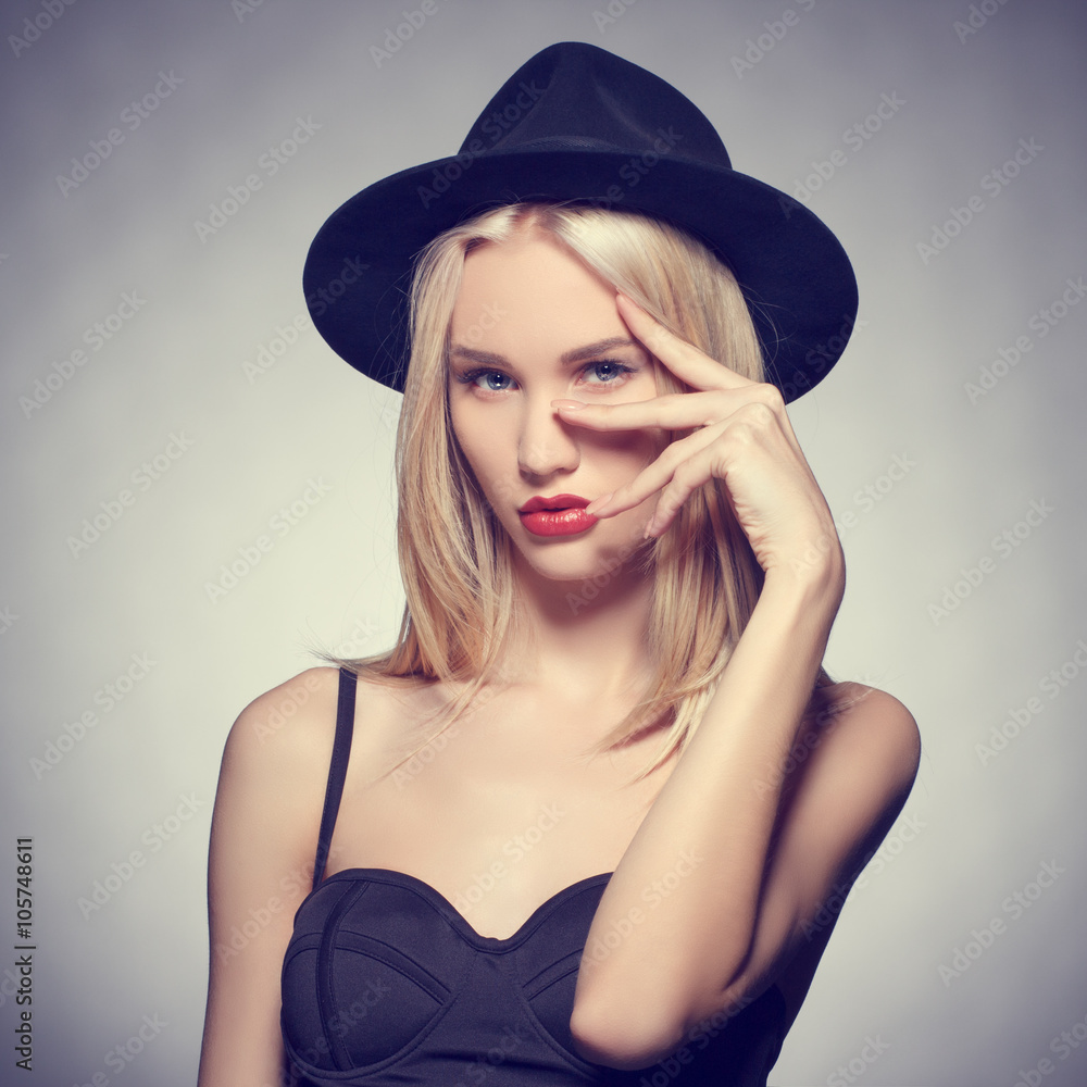 Luxury blonde young woman in a stylish black hat . Beauty portrait. Luxury blonde young woman in a stylish black hat . Beauty portrait.