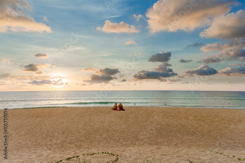 A pair of lonely tourist sitting at the beach on Phuket