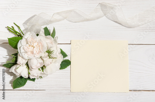 white roses with empty card for you text on white table.top view